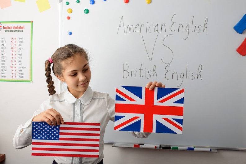 20230829063102_[fpdl.in]_cheerful-schoolgirl-with-american-british-flags-classroom-learning-differences-types-english-languages_123211-1827_medium